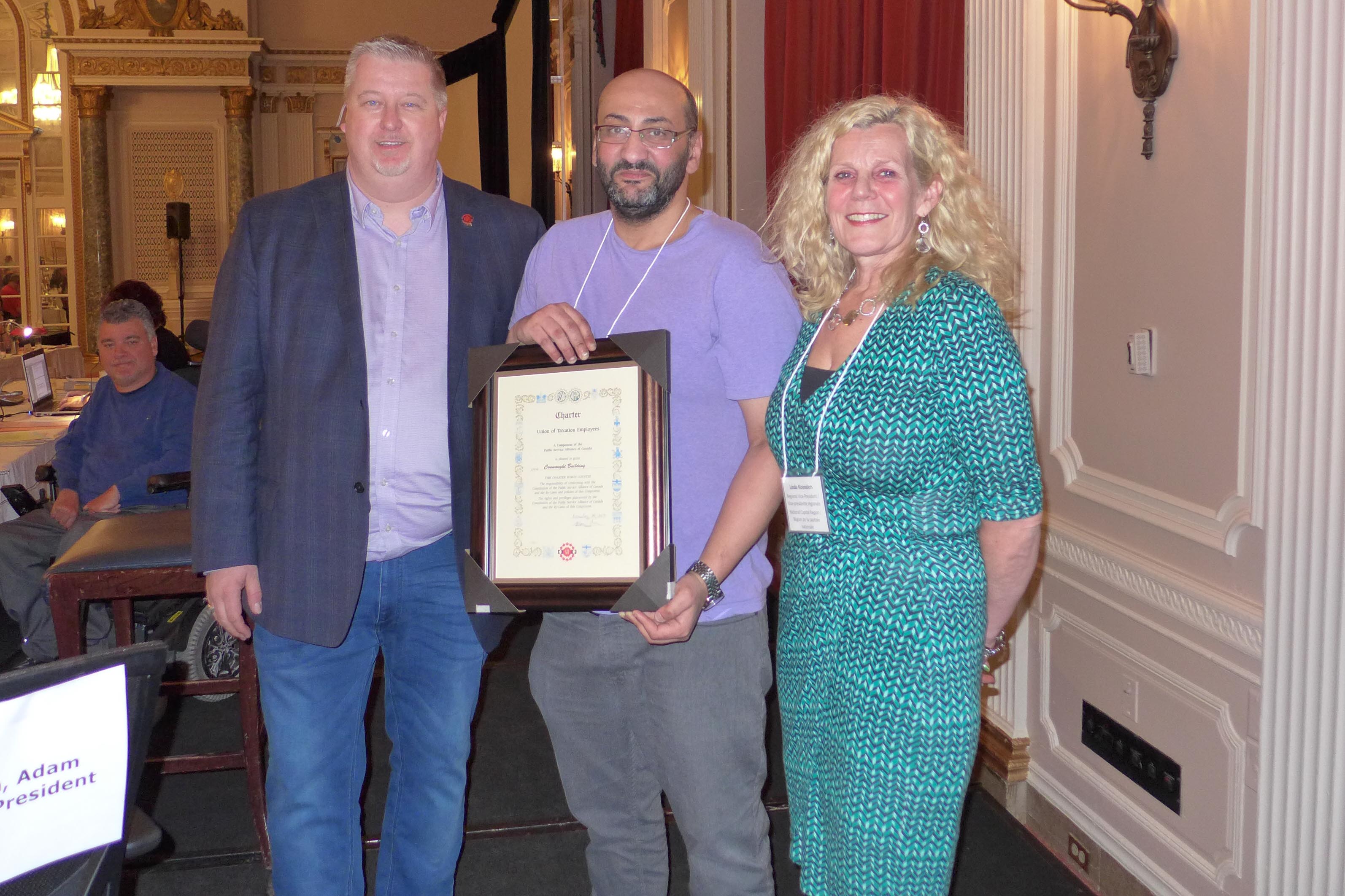 National President, Marc Brière and Linda Koenders, RVP for the NCR present Shady Zekry, President of Local 70021 - Connaught Building with the local's Charter